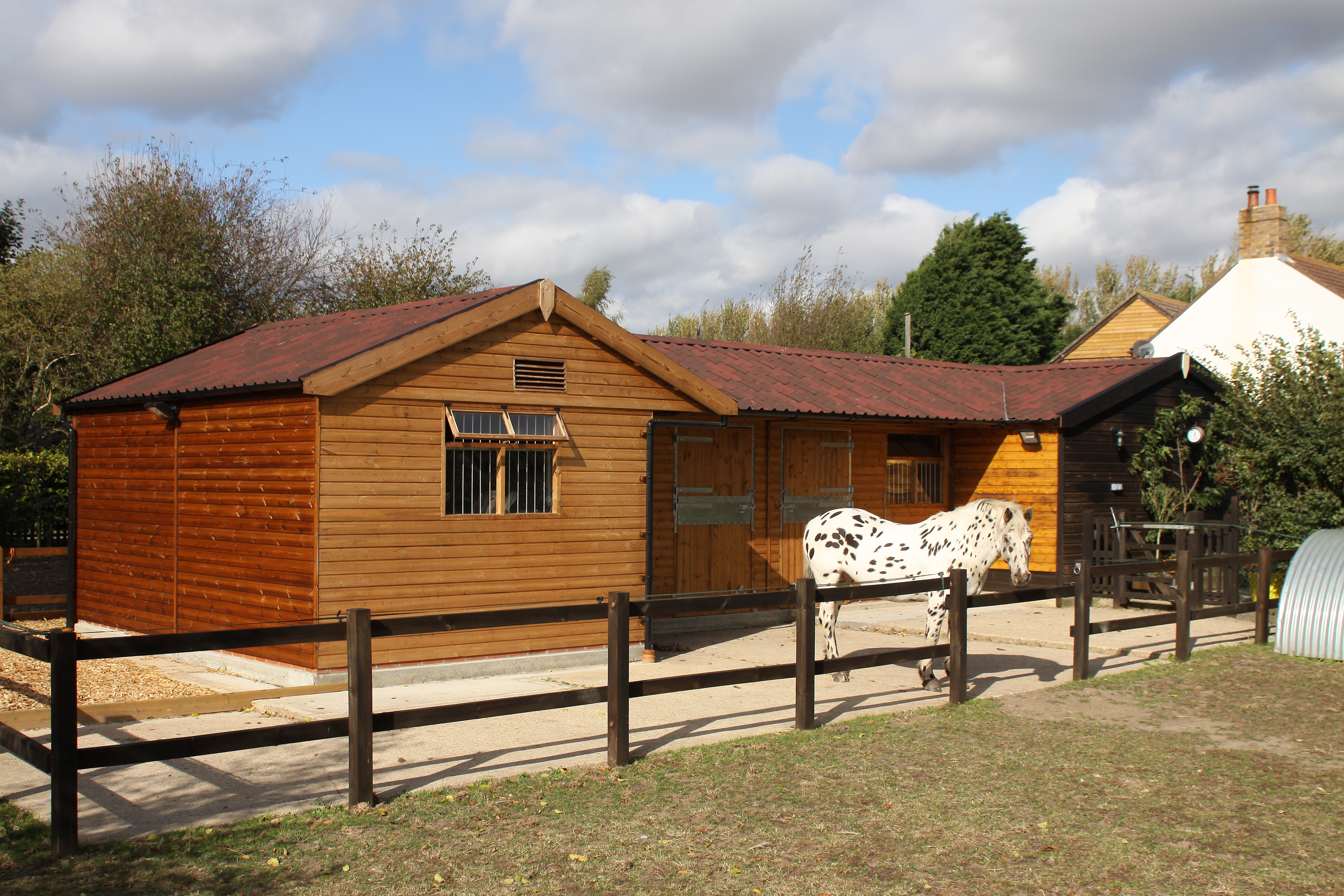 red wood stable with ONDULINE roofing
